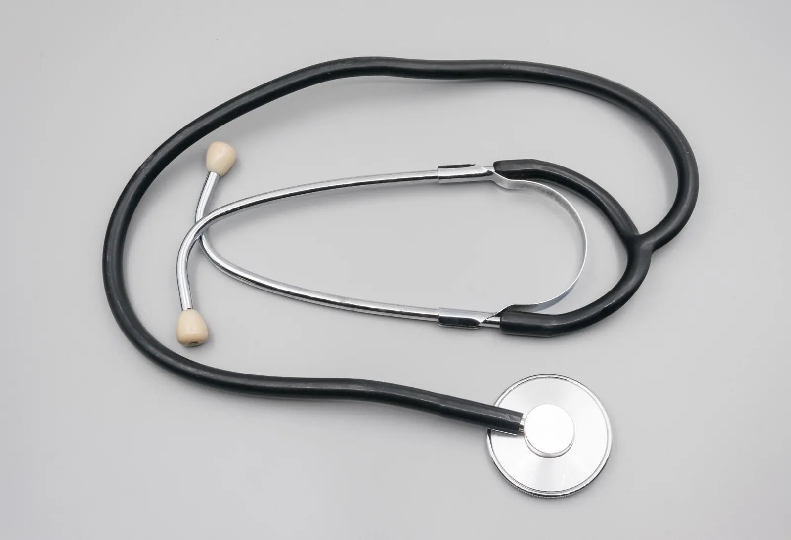 A stethoscope on a grey table